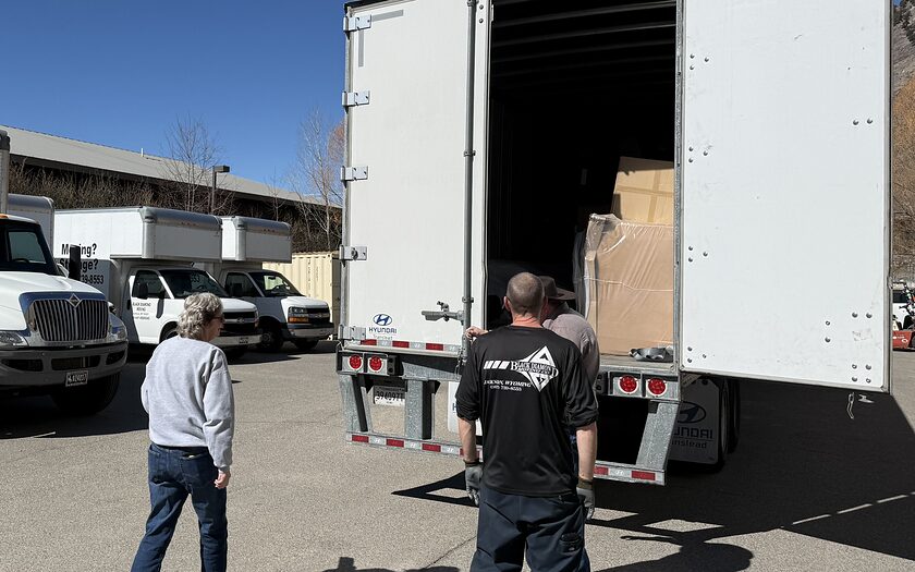 Black Diamond box trucks in the Jackson yard with crew loading a trailer.